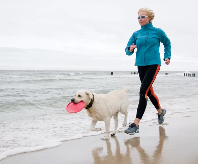 Running on beach with dog
