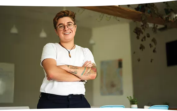 Standing in room with arms crossed